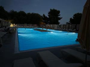 a large swimming pool lit up at night at Villa Kiara in Vodice