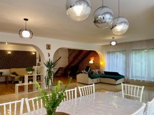 a living room with a table and a couch at Casa Zena Predeluț in Predeluţ +40 photos