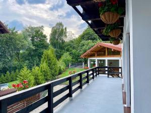 a balcony of a house with a view of a garden at Casa Zena Predeluț in Predeluţ