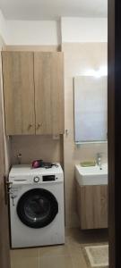 a small kitchen with a washing machine and a sink at Agrikia House fully renovated peaceful 1km from Plakias beach in Plakias +29 photos