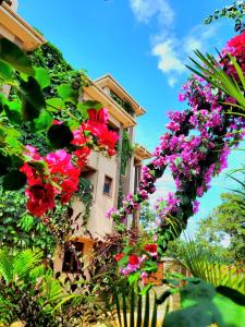 a building with flowers on the side of it at La Vista Residences and Safaris in Jinja