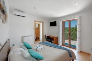 a bedroom with a large bed with blue pillows at Cynara holiday house in Massa Lubrense