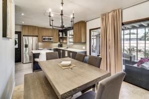 a kitchen and dining room with a wooden table and chairs at 1 Block to Beach and Eats Modern Indialantic Apt in Indialantic +17 photos