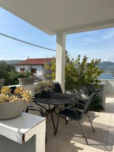 a patio with a table and chairs on a balcony at Adriatic Breeze Family Stay in Trogir