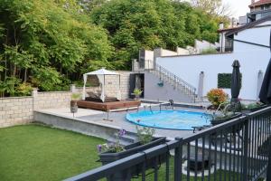 a backyard with a swimming pool and a fence at Villa Serenity in Balchik