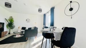 a living room with a dining room table and chairs at Entire Luxury 2 Bedroom Apartment - Quiet & Central with Free Parking in Birmingham +33 photos