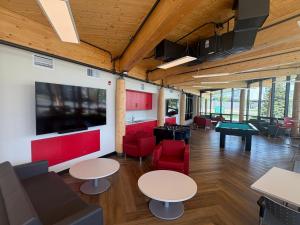 a room with tables and chairs and a pool table at Residence & Conference Centre - Kelowna in Kelowna