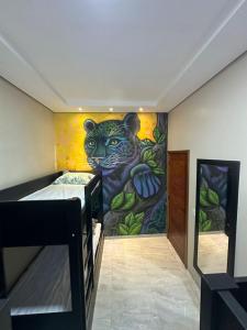 a room with a mural of a tiger on the wall at AMAZON INn JACARÉ in Cruzeiro do Sul +8 photos