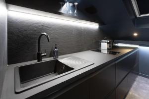 a kitchen with a sink and a counter at CEVA Suite Moonlight-Jacuzzi & Cinéma Centre ville in Saint-Étienne
