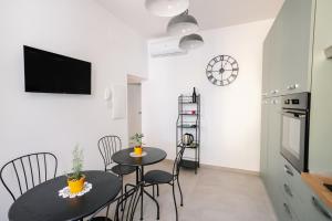 a kitchen and dining room with two tables and chairs at Domus Picena - Suites & Relax in Grottammare