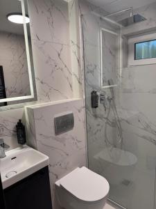 Un baño con ducha, inodoro y lavabo. en Turawa Lake Apartments, en Turawa