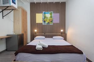 Postel nebo postele na pokoji v ubytování Hotel Lares 70 Laureles