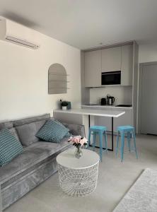 a living room with a couch and a table at CASA DEL MAR Apartamenty przy plaży in Pobierowo