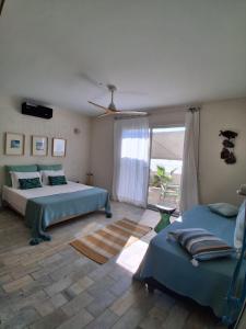 a bedroom with two beds and a large window at CasaEole in El Haouaria