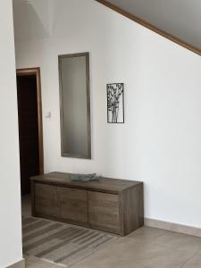 a room with a dresser and a mirror on a wall at Casa Azzurra Bijela Montenegro in Grabe +42 photos