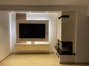 a living room with a flat screen tv on a wall at Kuća za odmor Ana in Zenica