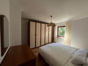 a bedroom with a white bed and a window at Apartman Reizer - FREE PARKING in Samobor
