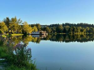 a reflection of a house on a lake at Bavarian Hideaway for Families in Waldkirchen