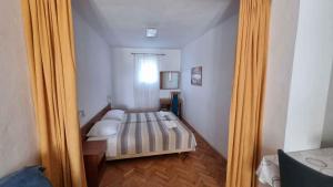 a reflection of a bedroom with a bed in a mirror at Apartment Ljubac 2 in Ljubač