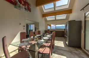 a dining room with a long table and a refrigerator at NEW! Villa l'or bleu -DUPLEX & MAINFLOOR- by Les éclectiques in Sévrier