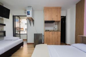 Postel nebo postele na pokoji v ubytování Hotel Lares 70 Laureles