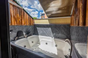 a bath tub sitting in a bathroom with at Hotel Lares 70 Laureles in Medellín +16 photos