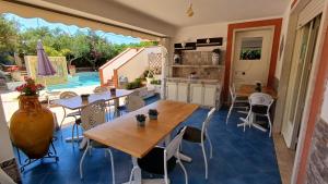 a kitchen and dining room with tables and chairs at Anastasia Villas-B&B in Lido Signorino
