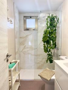 a bathroom with a shower with a plant in it at El beso del mar in Costa de Antigua