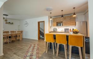 a kitchen and dining room with a table and chairs at Awesome Home In Novo Zvecevo With Sauna in Novo Zvecevo