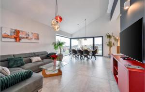 a living room with a couch and a table at Cozy Home In Dugo Selo With Sauna in Dugo Selo