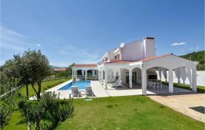 a white house with a pool and a yard at Awesome Home In Sestanovac in Šestanovac +41 photos