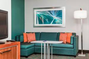 a living room with a couch and a table at SpringHill Suites Boston Peabody in Peabody