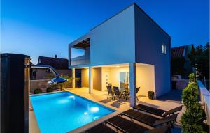 a house with a swimming pool in the backyard at 2 Bedroom Lovely Apartment In Obrovac in Obrovac