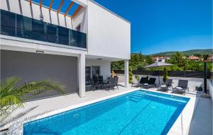 a house with a swimming pool next to a building at 2 Bedroom Lovely Apartment In Obrovac in Obrovac