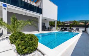 a swimming pool in the backyard of a house at 2 Bedroom Lovely Apartment In Obrovac in Obrovac +27 photos