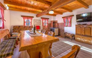 a living room with a wooden table and a tv at Nice Home In Gospic With Sauna in Gospić
