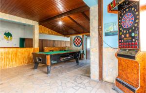 a room with a pool table and a dart board at Gorgeous Home In Jesenice Dugi Rat in Krilo
