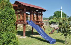 a playground with a blue slide in the grass at Gorgeous Home In Sinj in Sinj +38 photos