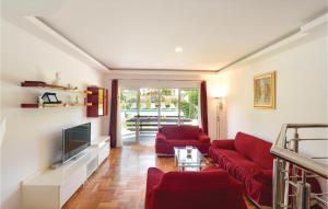 a living room with two red couches and a television at Gorgeous Home In Sinj in Sinj