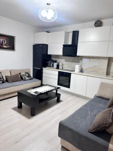 a living room with a couch and a table at Arena Apartament 2 in Elbasan