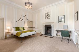 a bedroom with a bed and a fireplace at The Chapel Suite in Marske