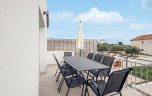 a patio with a table and chairs on a balcony at 4 Bedroom Gorgeous Home In Vrsi in Vrsi