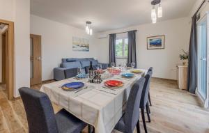 a dining room with a table and some chairs at 4 Bedroom Gorgeous Home In Vrsi in Vrsi