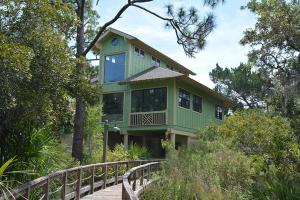 a green house on top of a bridge at 46 Davis Love Cottage in Fripp Island