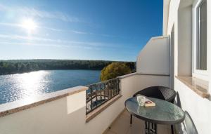 a balcony with a table and a view of the water at 1 Bedroom Nice Apartment In Krusevo in Kruševo
