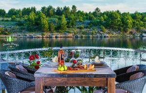 a table with a bottle of wine and fruit on it at 1 Bedroom Nice Apartment In Krusevo in Kruševo