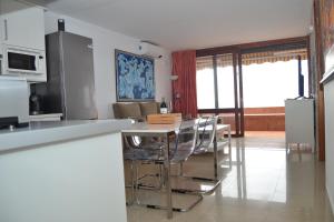 a kitchen with a table and chairs in a room at Looking the VIEWS - 214 in Costa Del Silencio