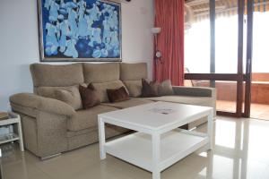 a living room with a couch and a coffee table at Looking the VIEWS - 214 in Costa Del Silencio