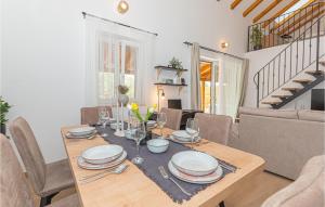 a dining room with a table with plates and glasses at Beautiful Home In Sibenik With Kitchen in Šibenik