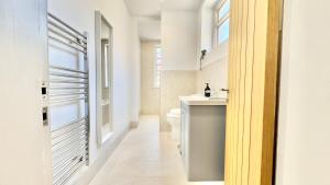 a bathroom with a white toilet and a sink at The Bank in West Kirby +19 photos